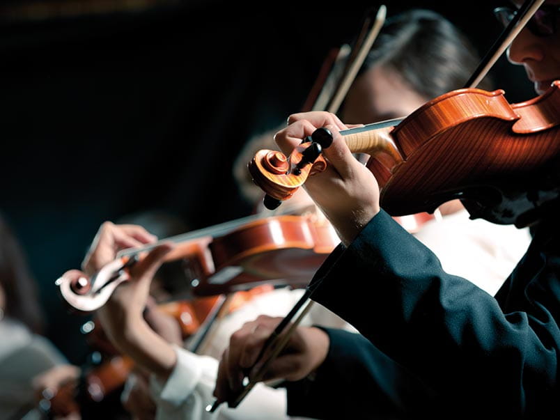 Violinists playing in an orchestra